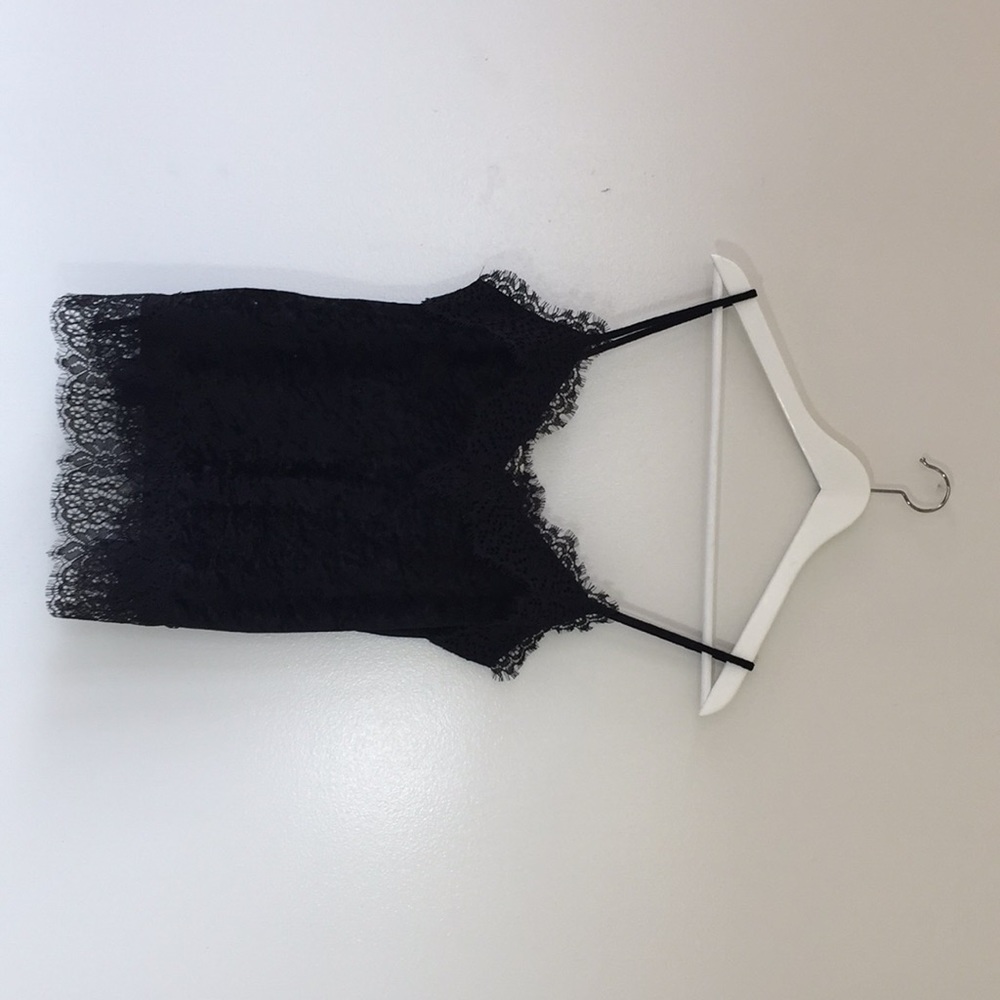 Tank top with lace detail to top and bottom.